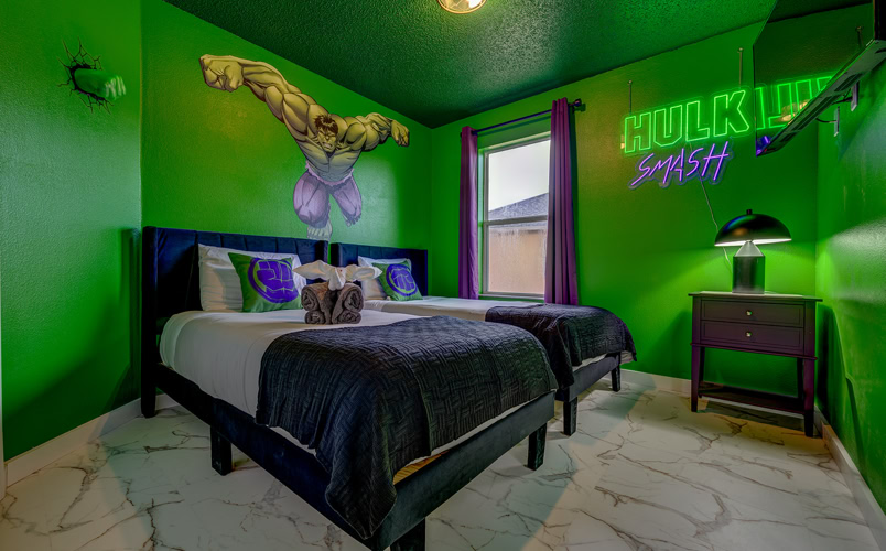 Hulk Smash Themed Bedroom – Kissimmee Vacation Home Rental Green Hulk themed twin bedroom with neon wall art at Marble Studios Florida in Kissimmee